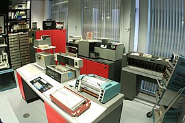 Large IBM 1130 systems still handled paper tape in the early 1970s (at left of console)