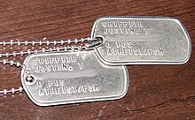 Two metal US Army dog tags with Atheist/FSM stamped on them