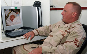 Tech. Sgt. Troy Goodman watches the newest member of his family via webcam