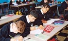 School pupils writing at desks