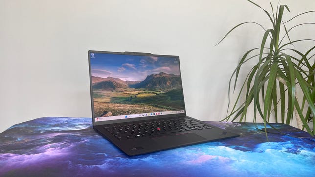 Lenovo ThinkPad X1 Carbon Gen 12 laptop next to a plant