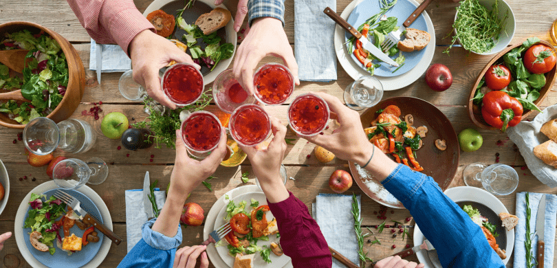 Aerial view people toasting with glasses over table 