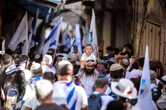 Israelis march through the alleyways of Jerusalem's Old City to the Western Wall, waving Israeli flags on 'Jerusalem Day' to commemorate the establishment of Israeli control over the city.