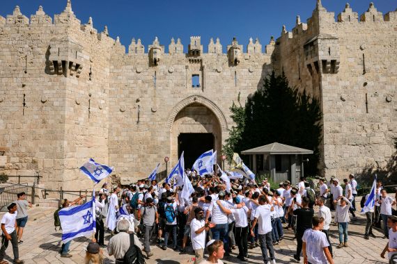 Israelis march through the alleyways of Jerusalem's Old City to the Western Wall, waving Israeli flags on 'Jerusalem Day' to commemorate the establishment of Israeli control over the city.