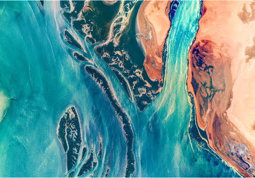 Aerial photo of a brightly-colored river delta.