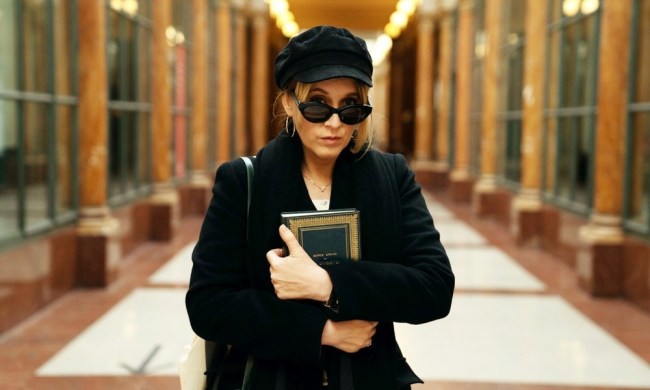 A stylish woman holds a book in Lupin.