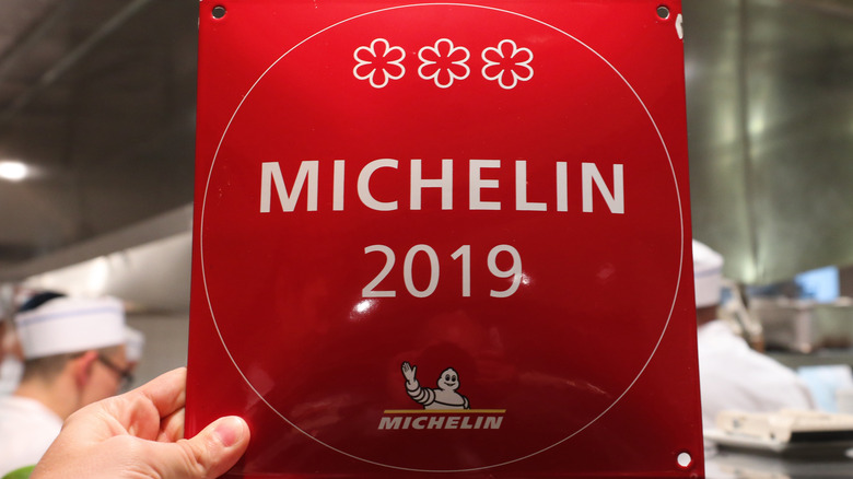 hand holding Michelin star plaque