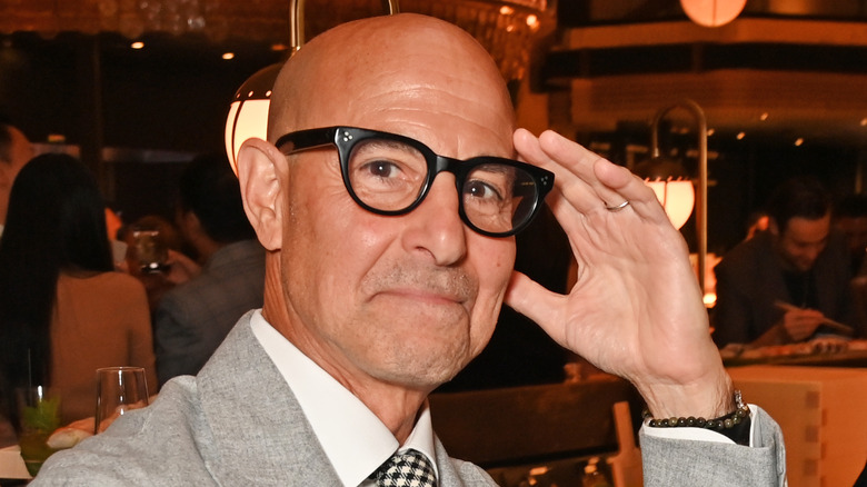 Stanley Tucci smiling at Harrods dining hall relaunch in 2023