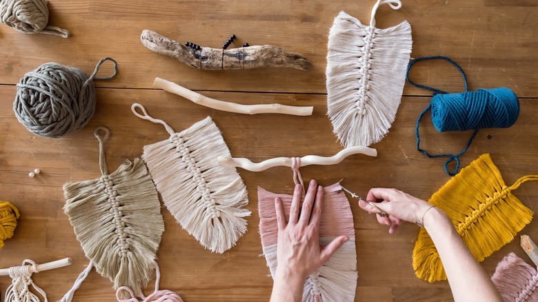 person making macrame feathers
