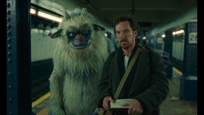 Benedict Cumberbatch stands on a subway platform with a furry, blue and white puppet monster in the Netflix series 'Eric'