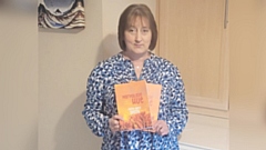 Oldham author Donna Marie Smith shows off a copy of Marmalade Hue