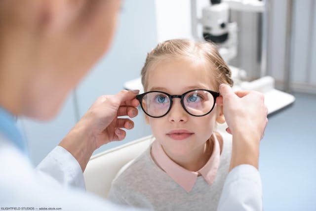 Optometrist fitting eyewear on child Image credit: ©LIGHTFIELD STUDIOS - adobe.stock.com