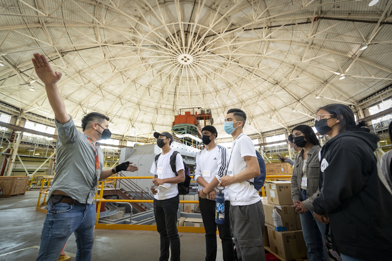 Group of students standing in the Advanced Light Source dome with a tour guide.