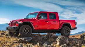 The 2023 Jeep Gladiator climbing over rocks