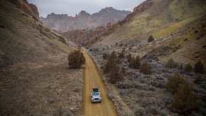 A Jeep Wrangler 4xe, the most popular PHEV in America, drives across a trail.