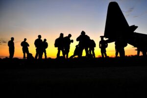 Green Berets prepare to board a KC-130 aircraft.