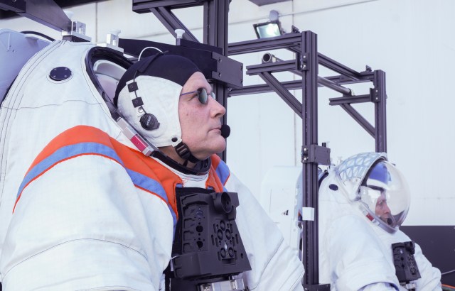 NASA astronaut Doug “Wheels” Wheelock and Axiom Space astronaut Peggy Whitson prepare for a test of full-scale mockups of spacesuits developed by Axiom Space and SpaceX’s Starship human landing system developed for NASA’s Artemis missions to the Moon.
