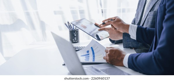 Using tablet pc, Consultant between bookkeepers and accounting lawyer consultation about asset, balance sheet, stock market statistics and yearly tax law, protect business from bribery. Stock Photo
