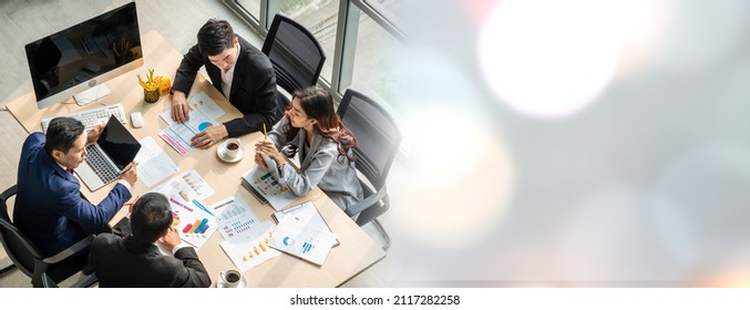 Business people group meeting shot from top widen view in office . Profession businesswomen, businessmen and office workers working in team conference with project planning document on meeting table . Stock Photo