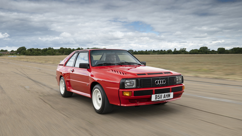 Red Audi Sport Quattro driving on a track