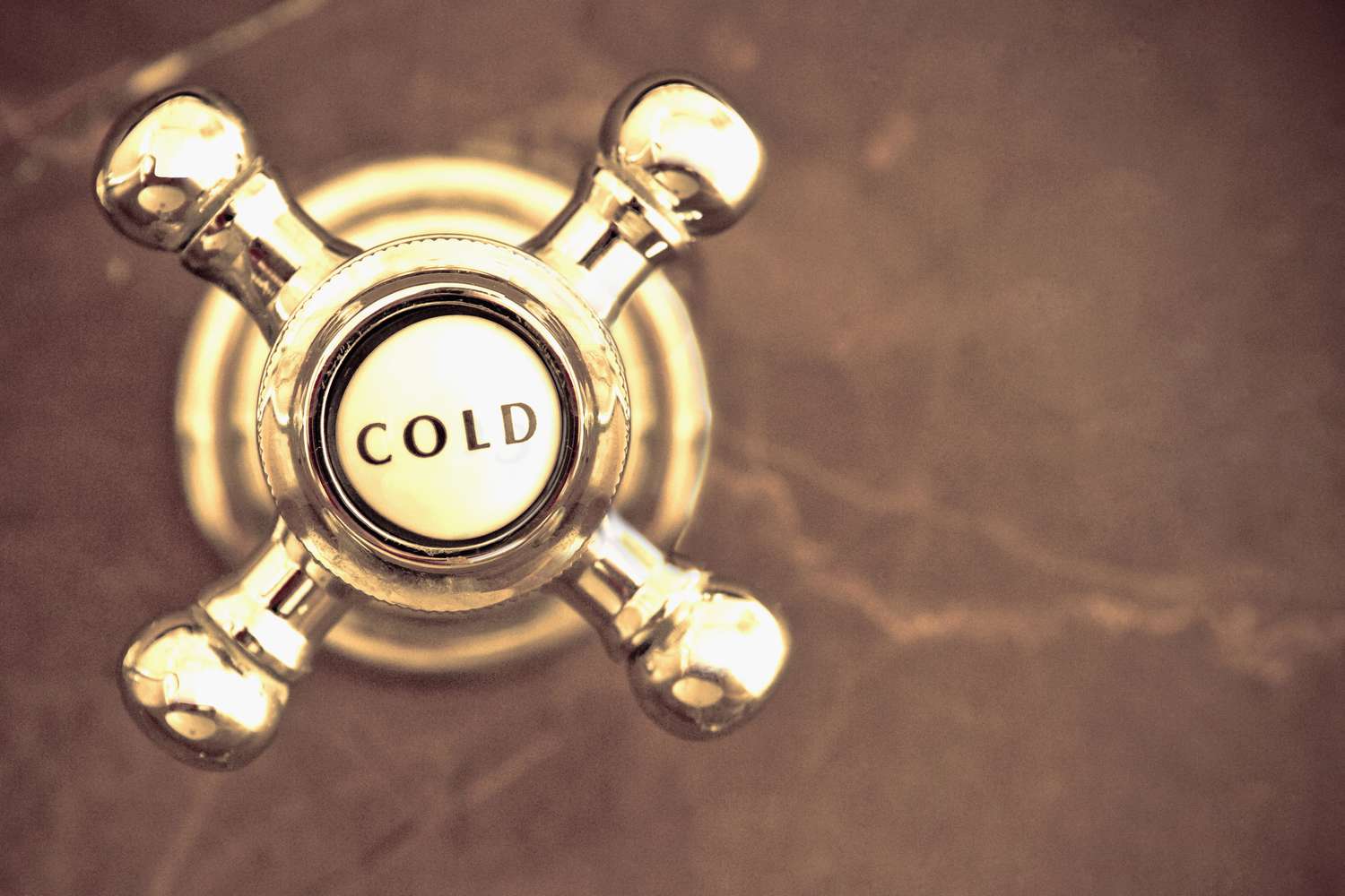 Close-up of a cold water shower knob