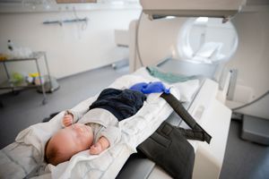 Baby sleeping on a gurney preparing for medical imaging