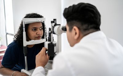 Eye doctor examining a person's eyes