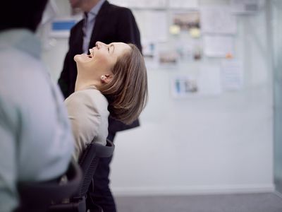 Businesswoman laughing reaction in office team meeting