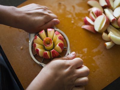 An image of a person cutting apples