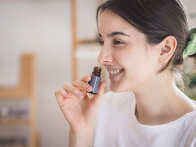 person smelling essential oil