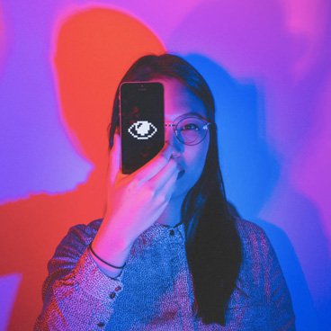 Photo of person with phone over their eye