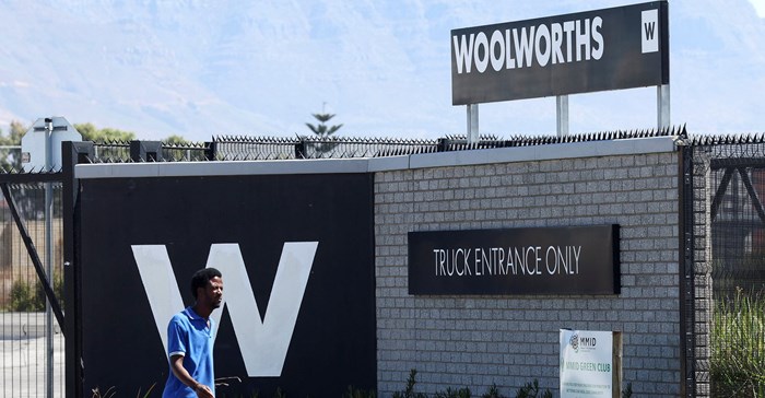 A man walks past the Woolworths truck entrance in Cape Town, South Africa, 26 February 2024. Source: REUTERS/Esa Alexander/file photo.