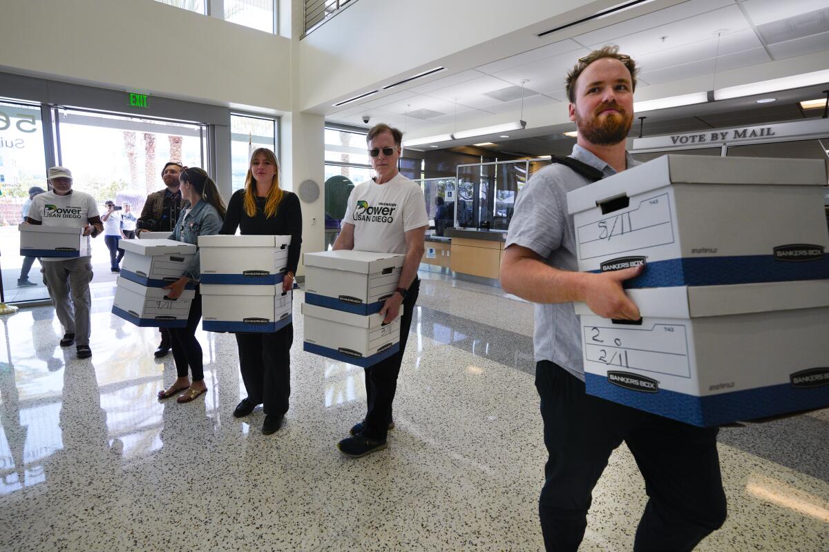 Supporters of Power San Diego deliver signatures to the San Diego County registrar of voters office.