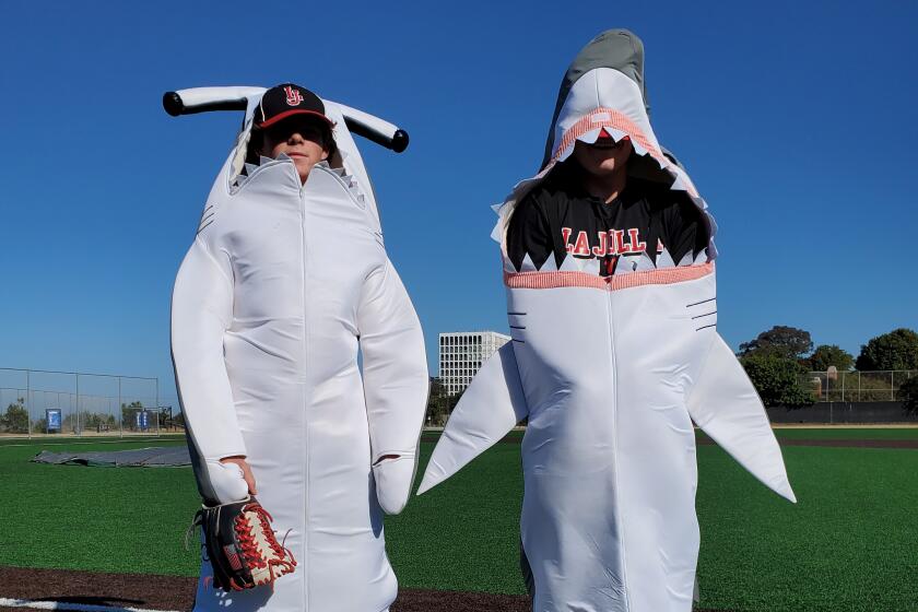 Ryan Kestler and Hank Hansen dress as sharks for La Jolla High School's Halloween baseball scrimmage.