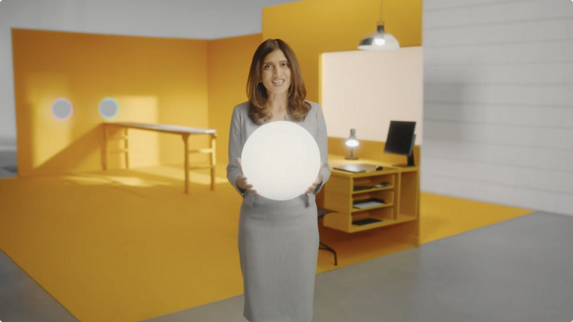 Uma mulher a segurar uma bola branca num escritório.