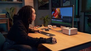 Apple Mac Studio Display: Woman at a desk using the Mac Studio Display