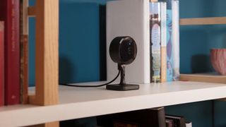 Eve HomeKit Secure Video camera on a bookshelf