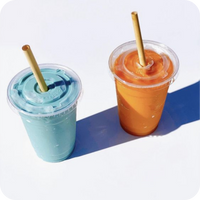 A blue and an ornage smoothie from Holy City Straw Company