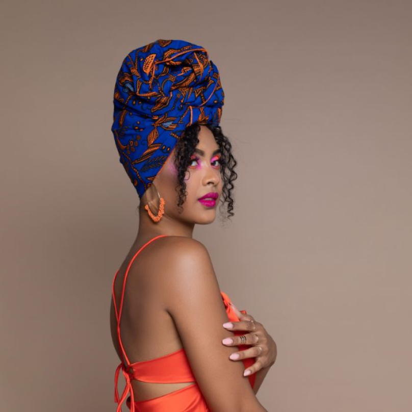 Uchenna Ngwudo, CEO at Cee Cee’s Closet, wearing vibrant colors and a blue headwrap