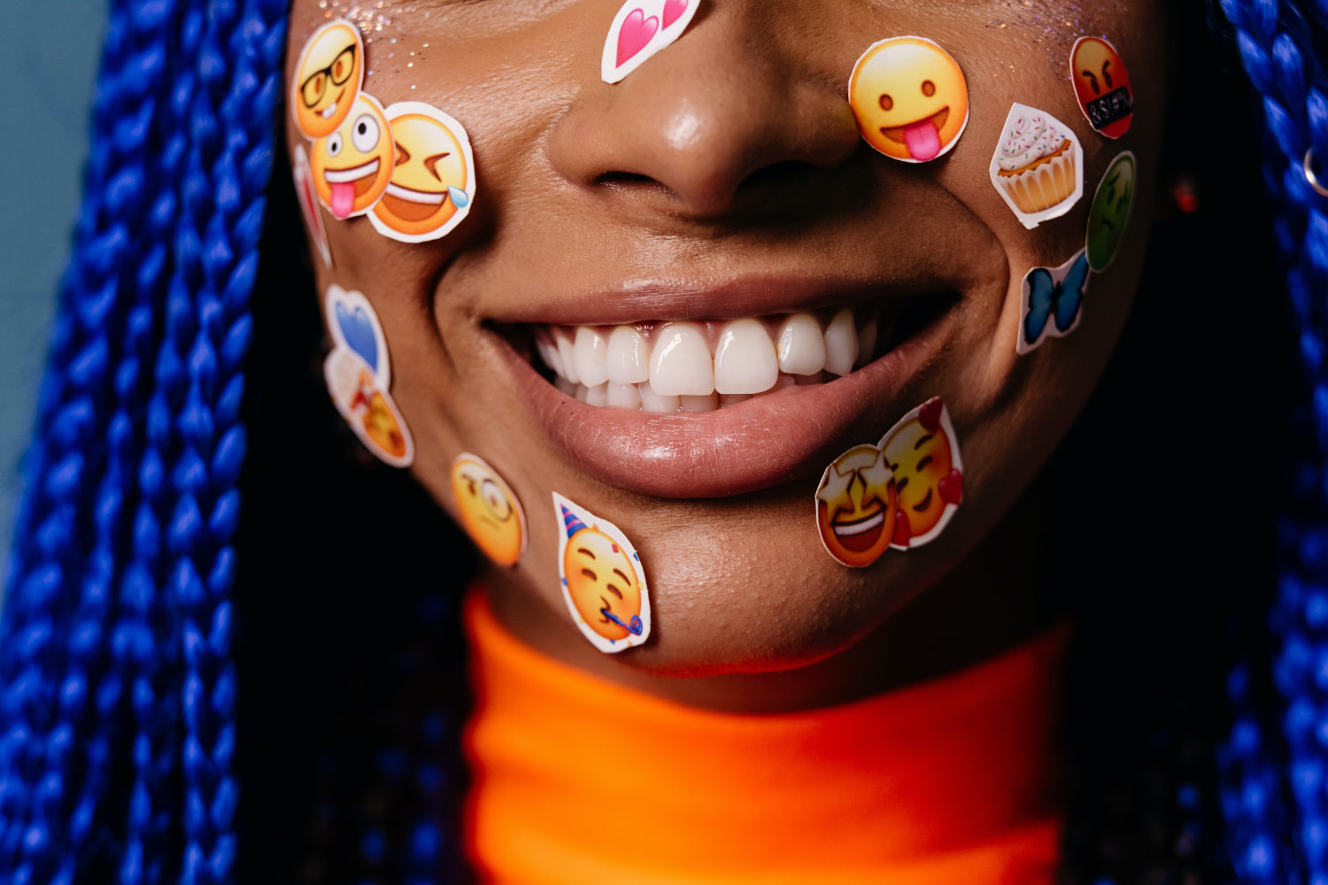 Woman's face covered in emoji stickers