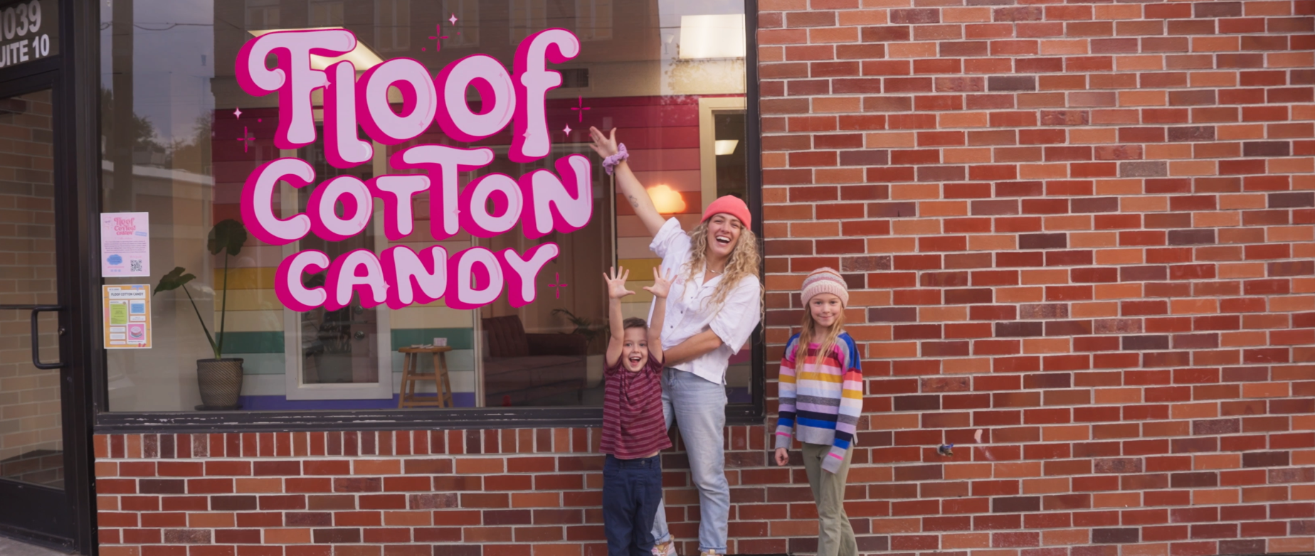 Founder Hannah Perry stands with kids in front of her storefront, Floof Cotton Candy