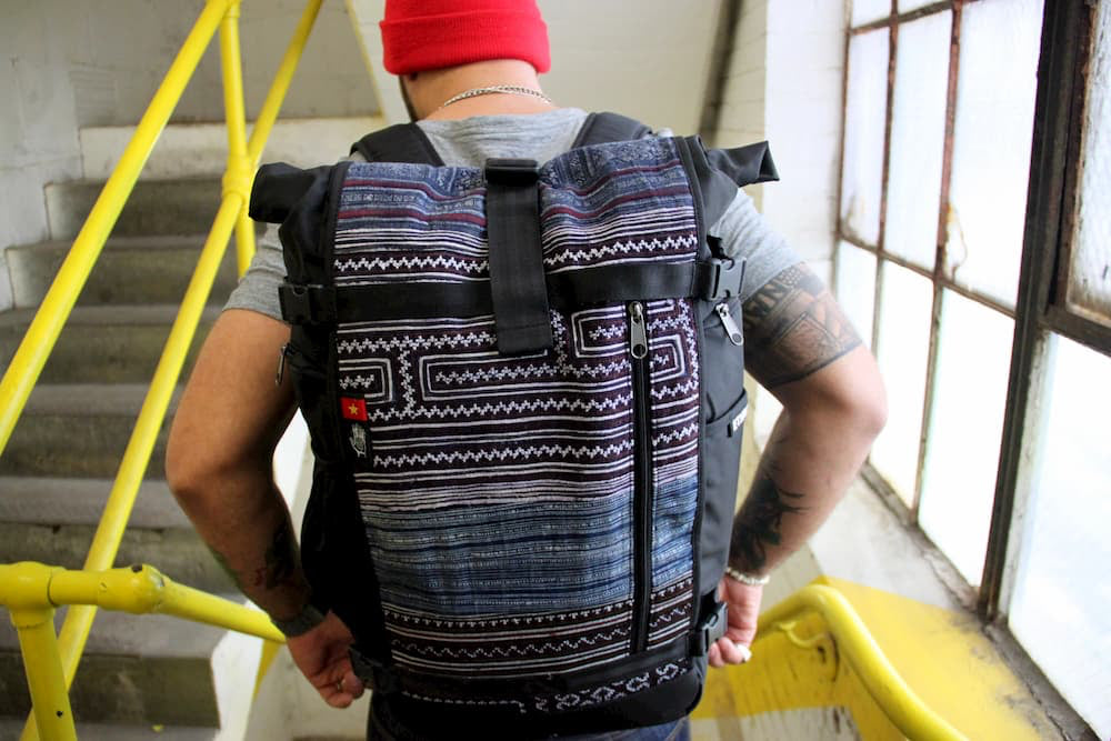 A person wears an Ethnotek backpack
