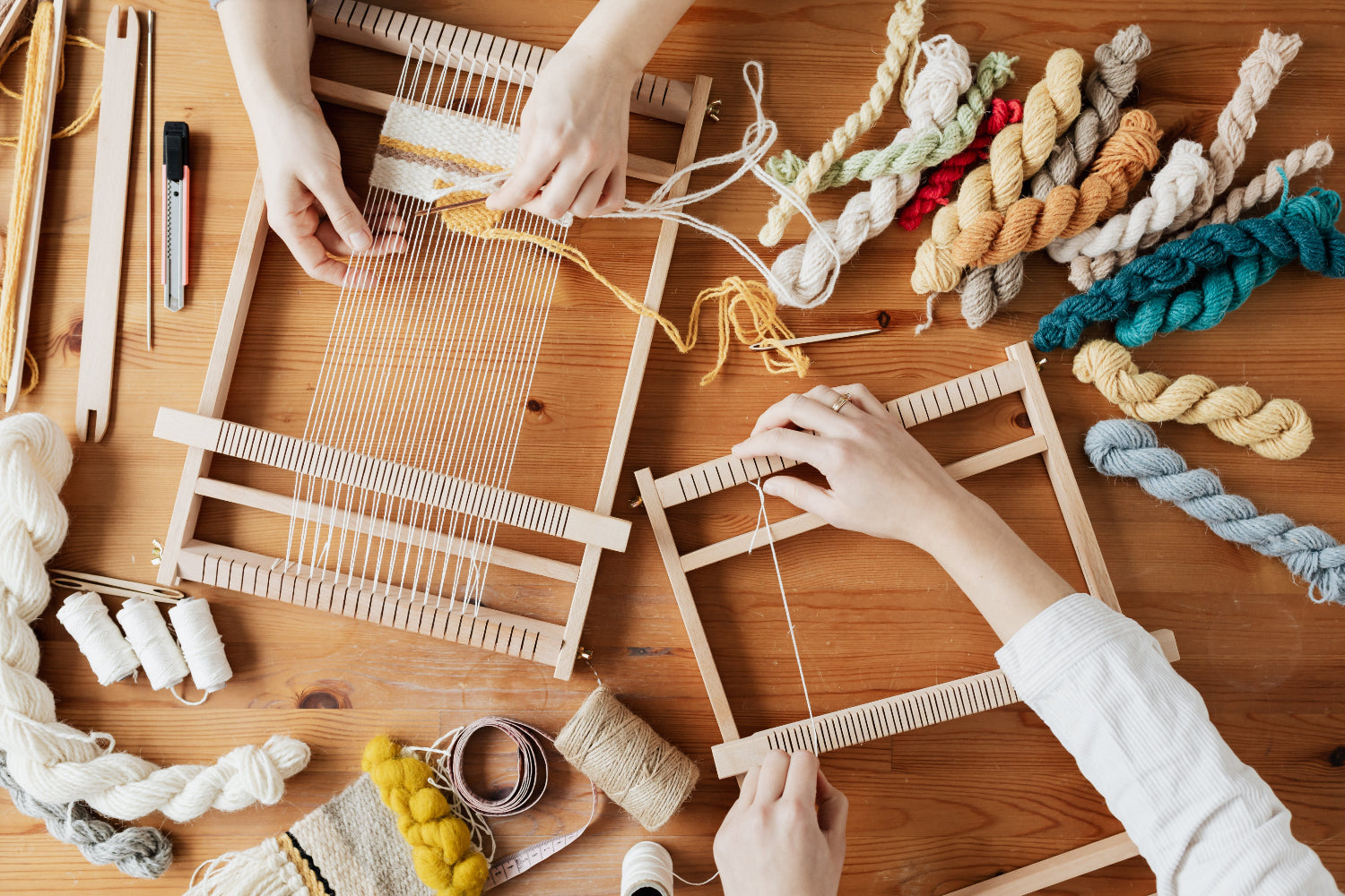 People make textile crafts on wooden looms