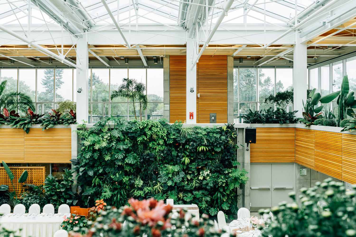 An airy two story event space full of plants