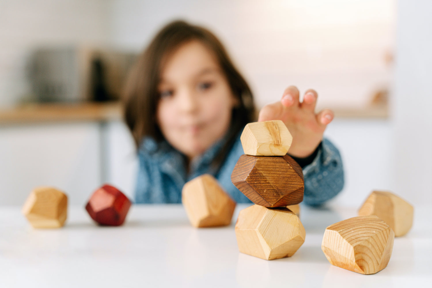 A child stacks wooden blocks