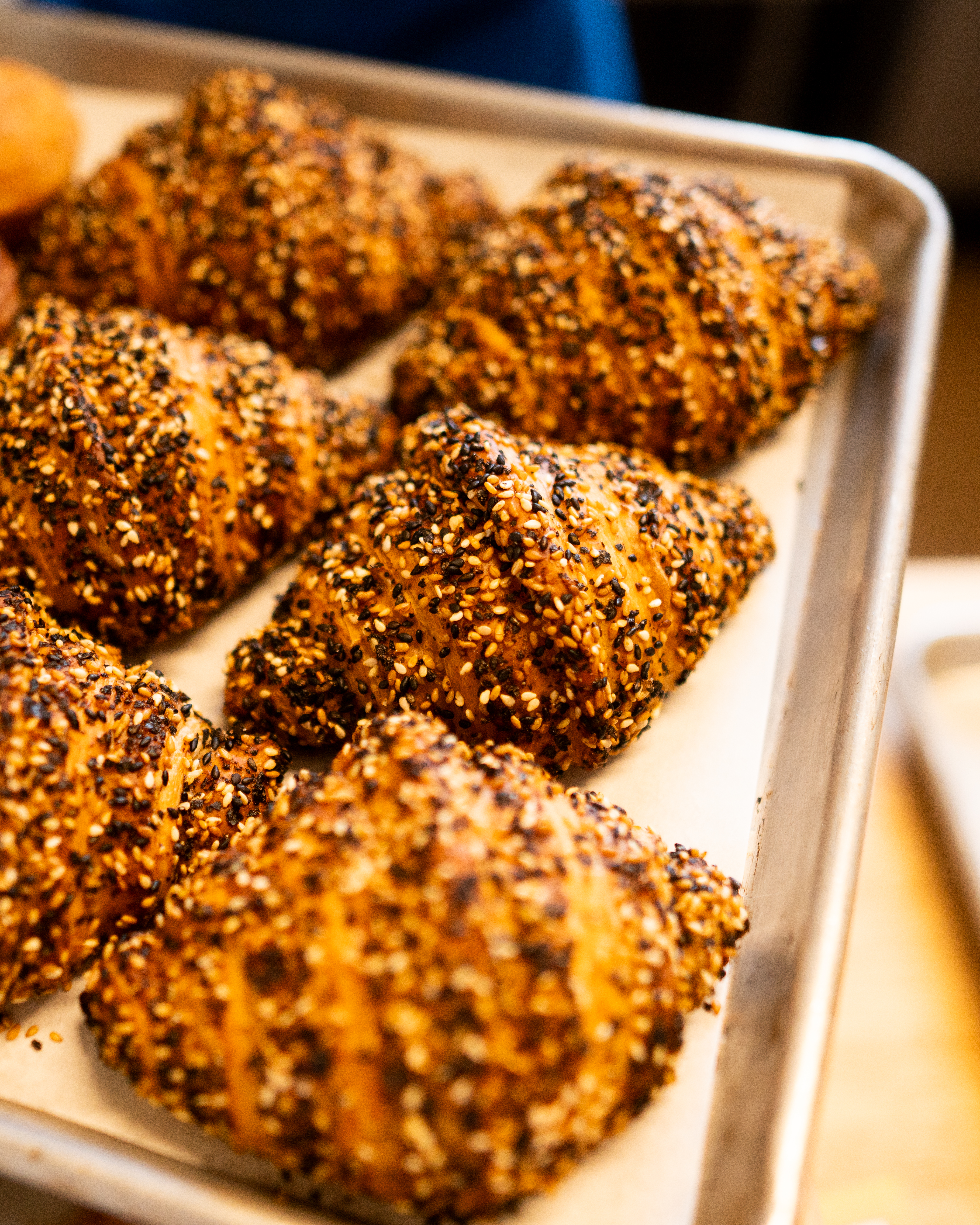 Croissants with sesame seeds on a baking tray