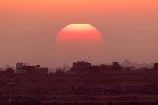 The sun sets over the Gaza Strip, amid the ongoing conflict between Israel and the Palestinian Islamist group Hamas, as seen from Israel