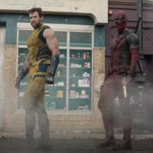 Deadpool and Wolverine walking through mist.