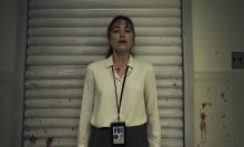 Maika Monroe stands against a garage door looking terrified in the film "Longlegs".