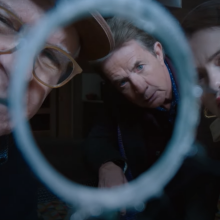 Charles (Steve Martin), Oliver (Martin Short), and Mabel (Selena Gomez) peer through a bullet hole in "Only Murders in the Building"